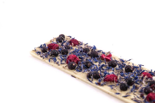 White chocolate with blue flowers, raspberries and black currants